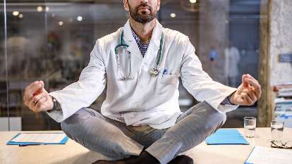 Promoting organizational wellness and culture; physician sitting and meditating