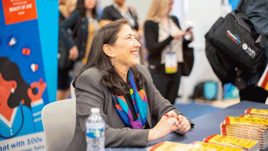 Valerie Alexander laughing at PracticeLInk booth