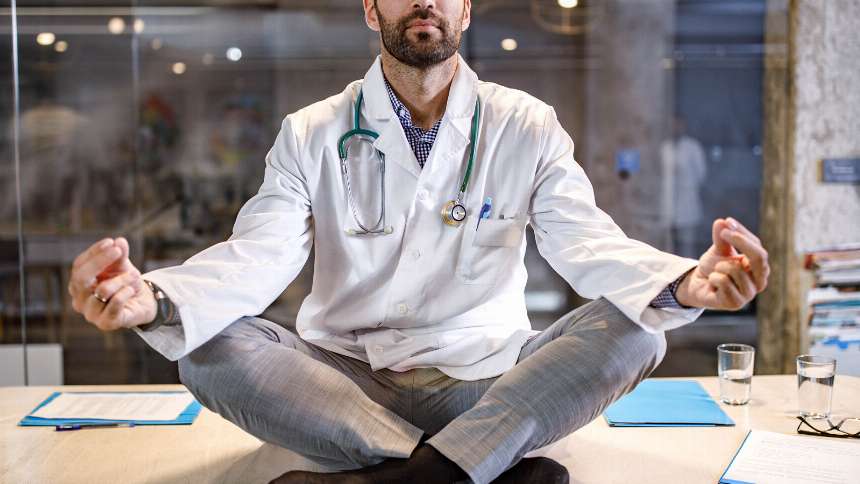 Promoting organizational wellness and culture; physician sitting and meditating